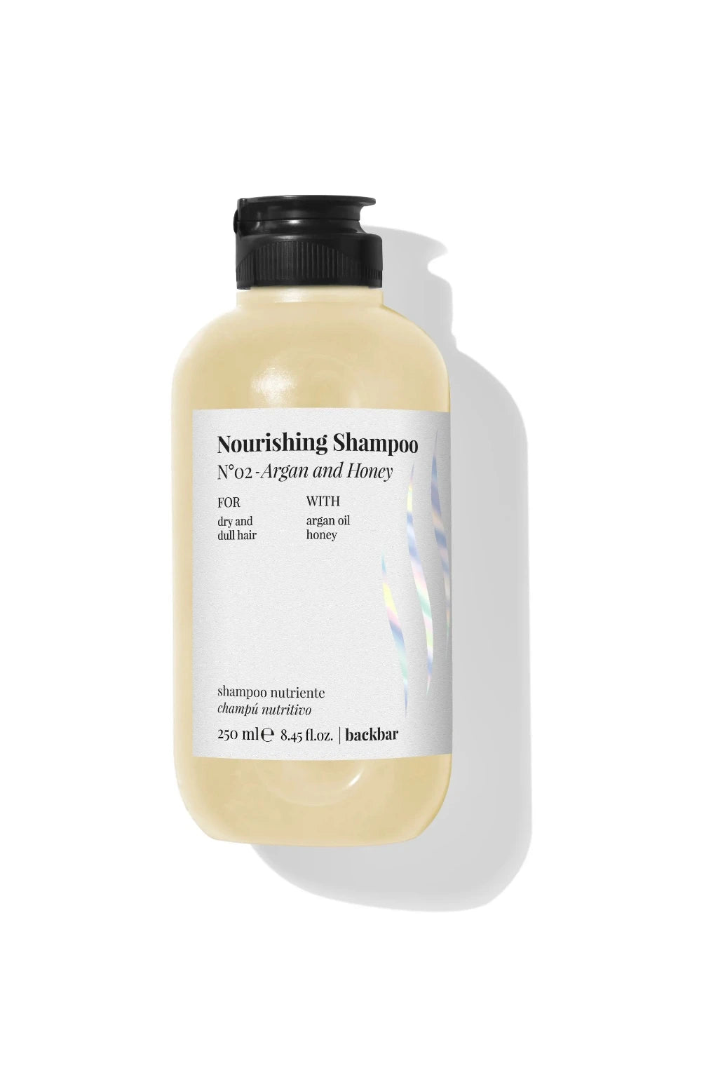 A bottle of haircare nourishing shampoo with a black pump dispenser and a white label, set against a clean white background with a soft shadow.