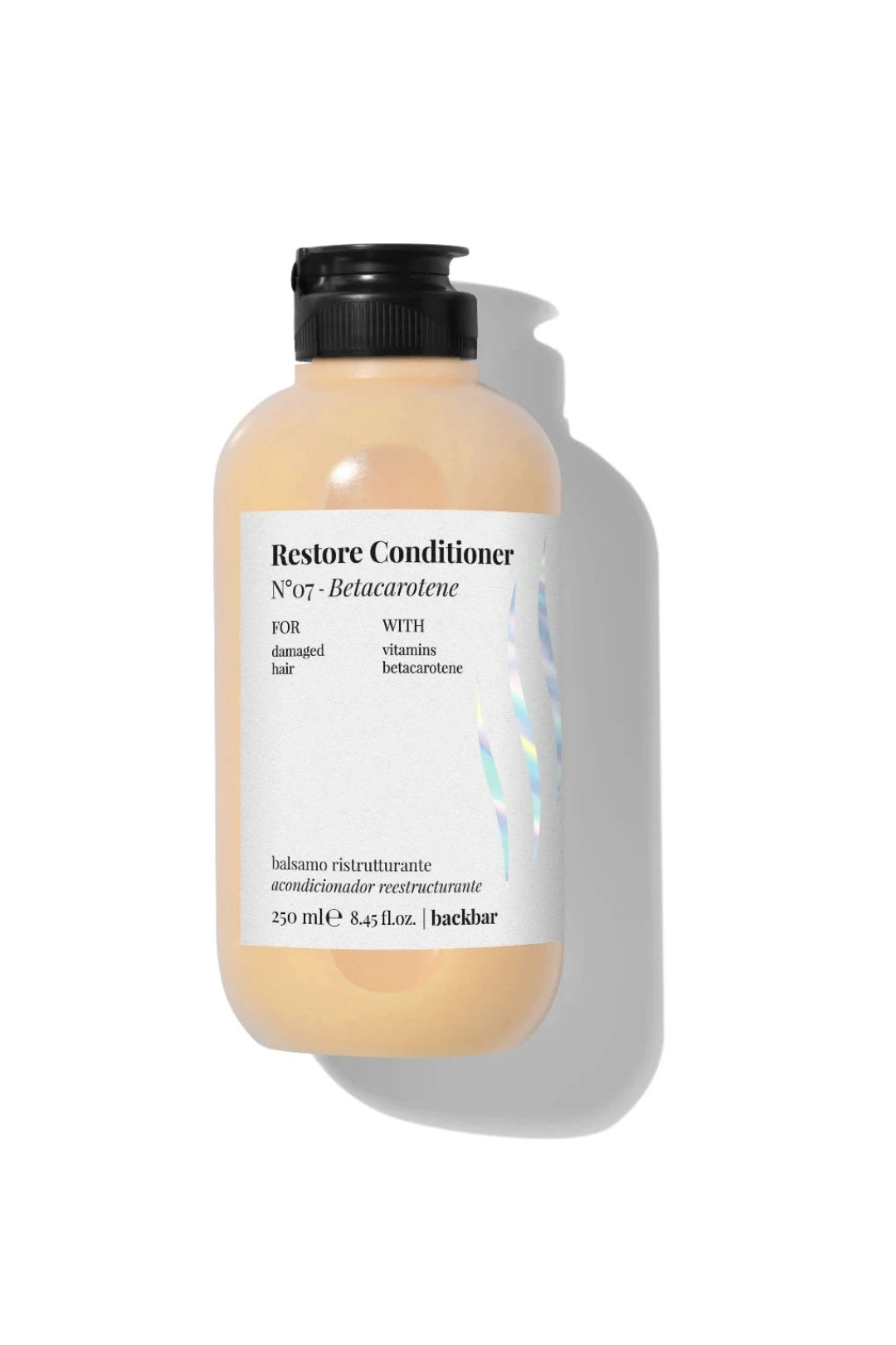 A bottle of hair conditioner with a black pump cap and a white label, shown on a clean white background with a soft shadow. The product is labeled 'Restore Conditioner' and has a warm peachy-beige tinted liquid inside.