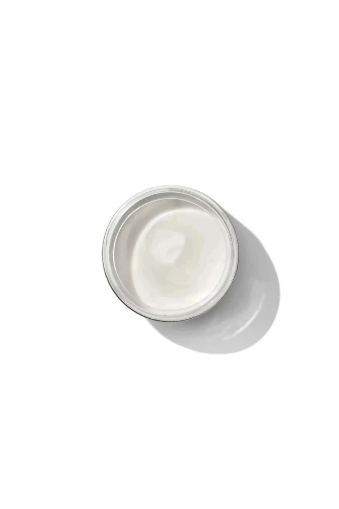 A small round white jar filled with white cream, photographed from above on a clean white background with a soft shadow.