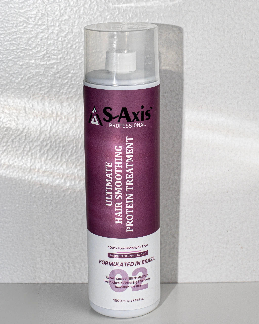 A bottle of S-Axis Professional Ultimate Hair Smoothing Protein Treatment, featuring a deep purple and white label with a clear cap, set against a textured white background.